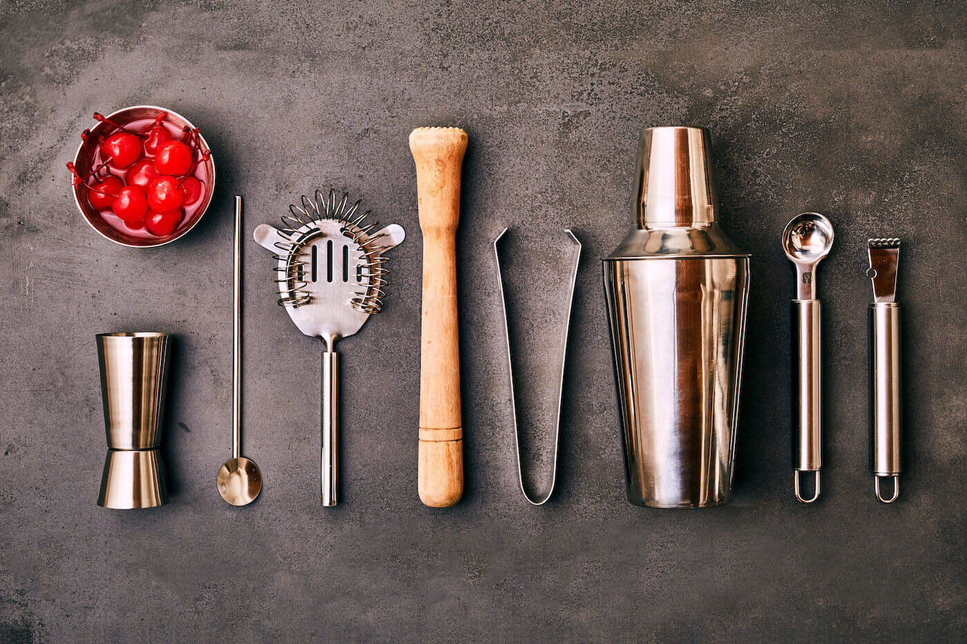 An assortment of essential bartending tools for beginners.