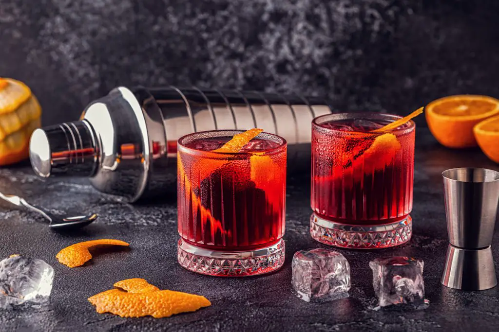 Negroni cocktail with orange peel and ice.