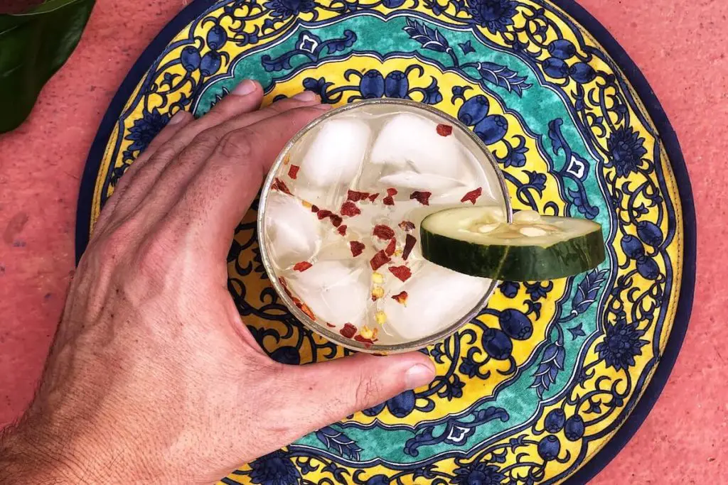 Mezcal Cocktail On Pink Table With Chili Flakes Jpg