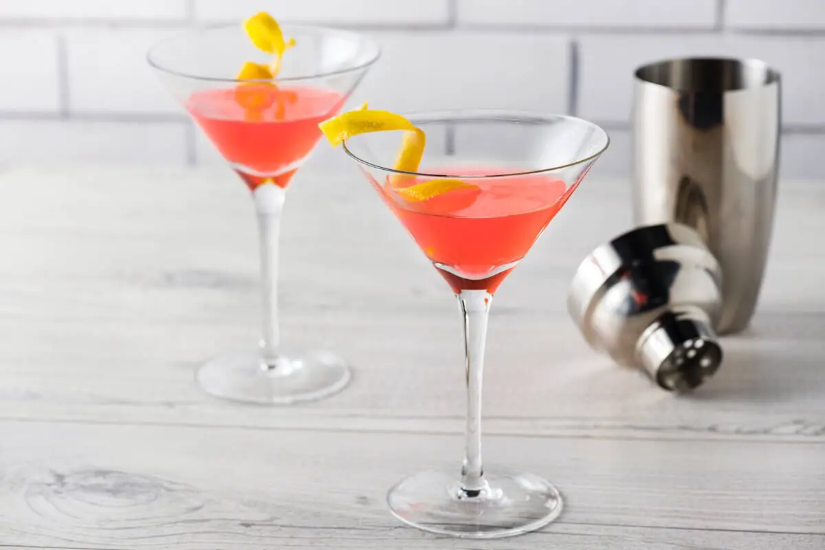 Cosmopolitan cocktail in martini cocktail glass and lemon twist garnish