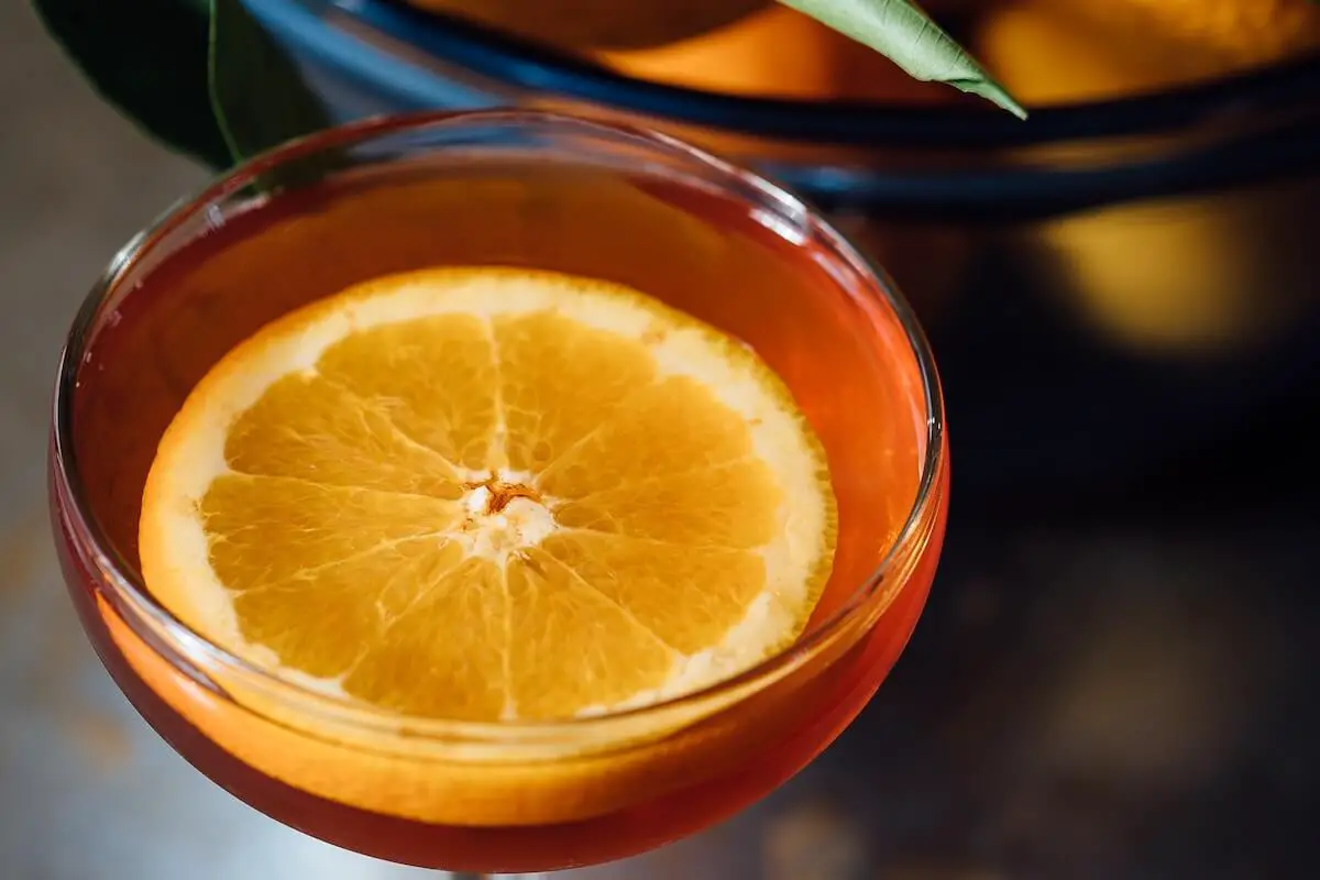 South beach cocktail with orange garnish.