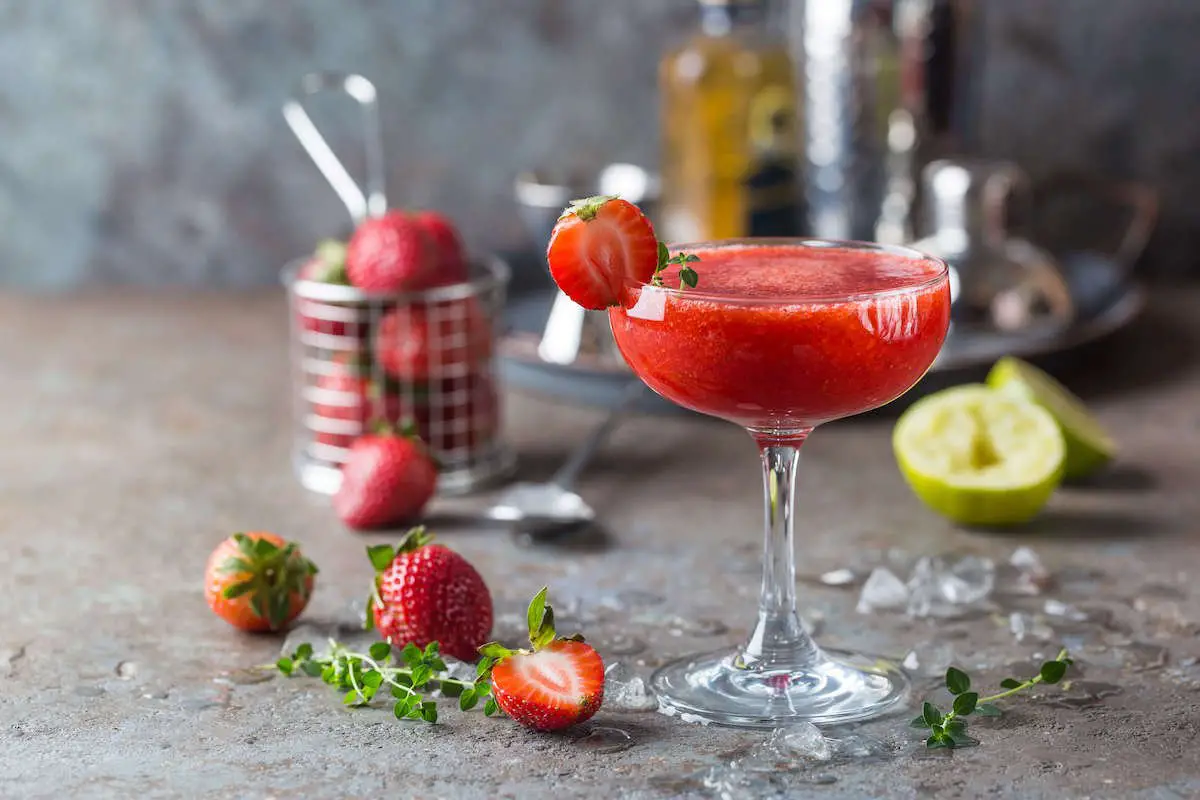 Frozen strawberry daiquiri cocktail in coupe glass