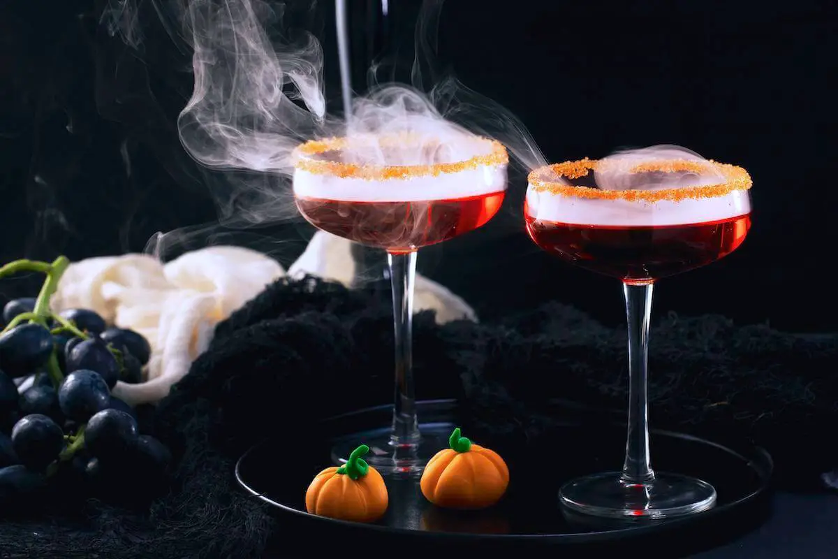 Two red halloween cocktails on tray